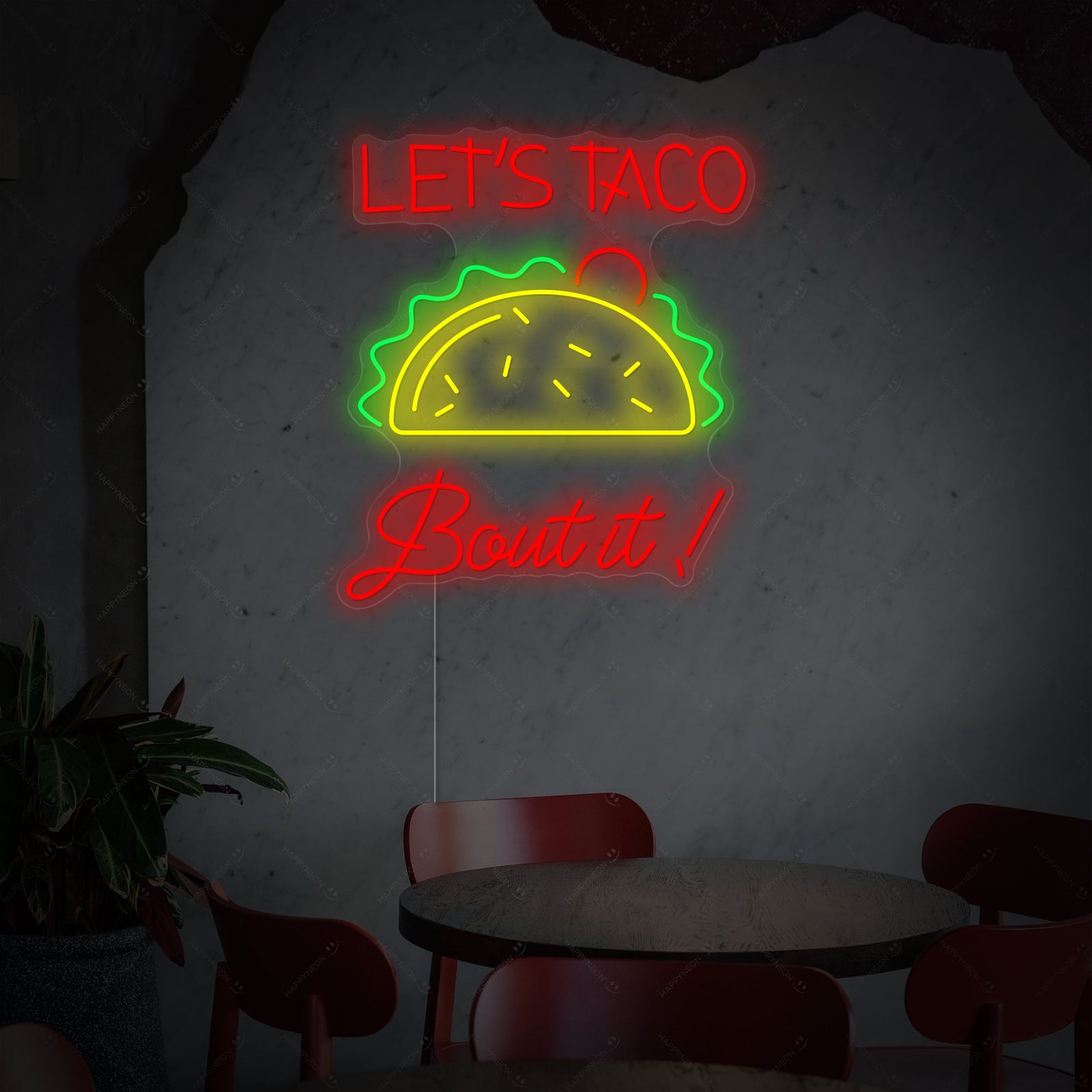 'Let's Taco Bout It' neon sign with a clear acrylic backing, ready for mounting as a piece of unique kitchen neon decor.