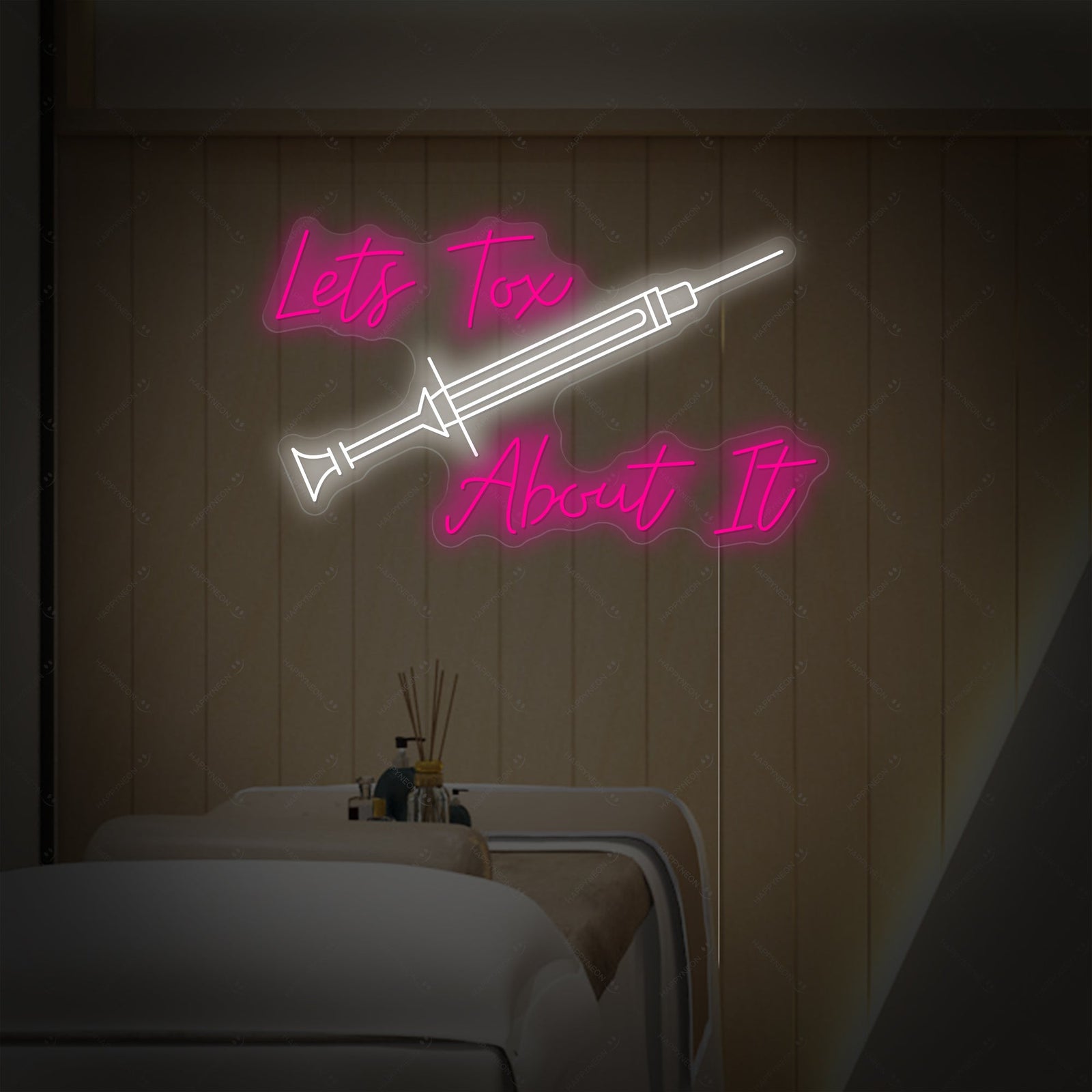 Close-up of a blue glowing 'Lets Tox About It' neon sign showing the tubing mounted on a clear acrylic background.