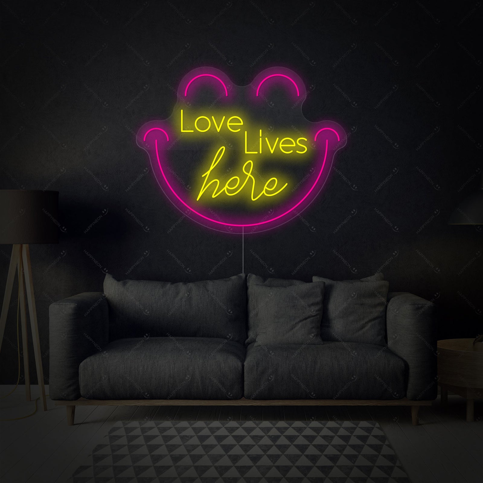 A close-up view of the "Love Live Here" neon sign showcasing its flowing script font mounted on a transparent backing.