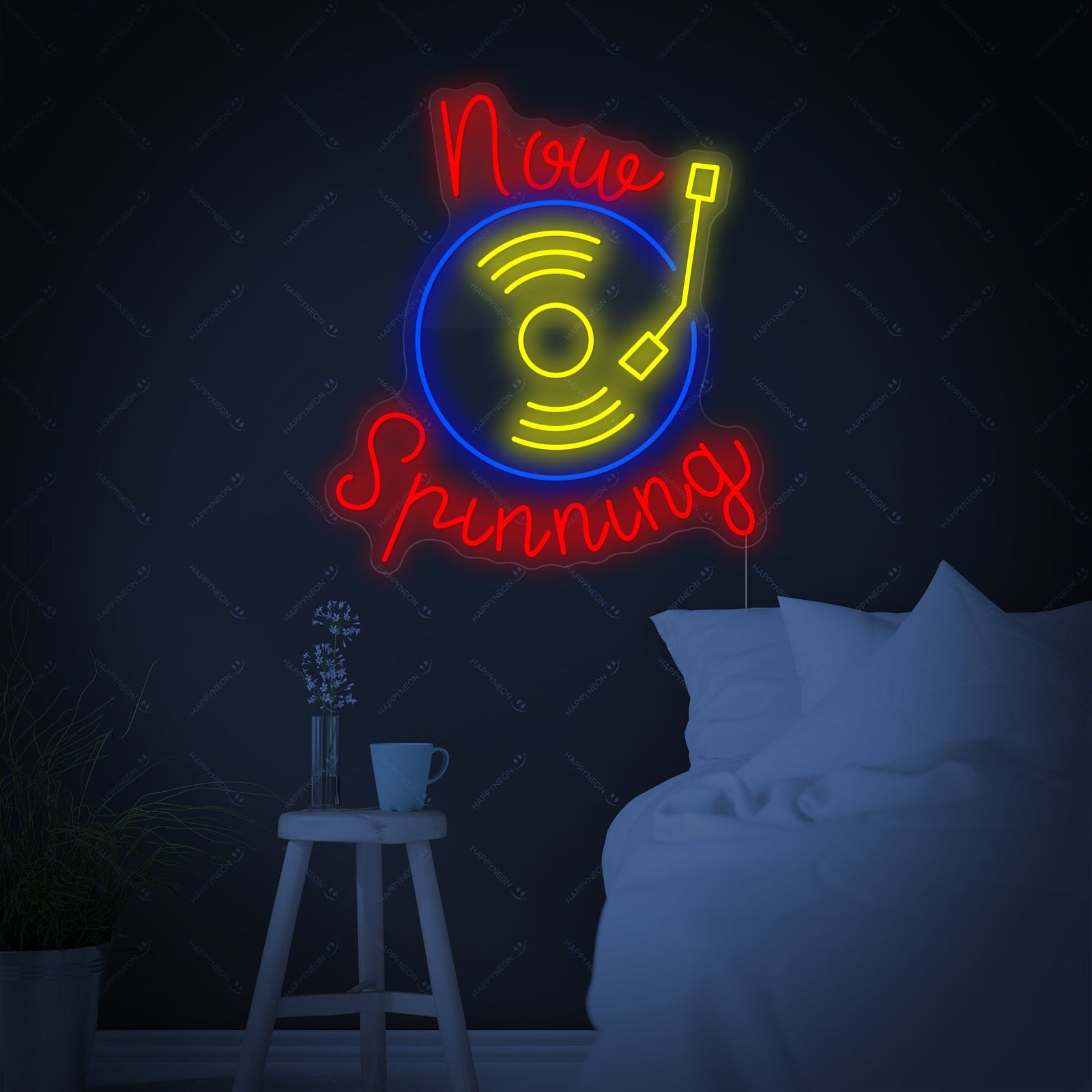 Close-up photograph of the 'Now Spinning' neon sign showing the lit tubes and acrylic backing