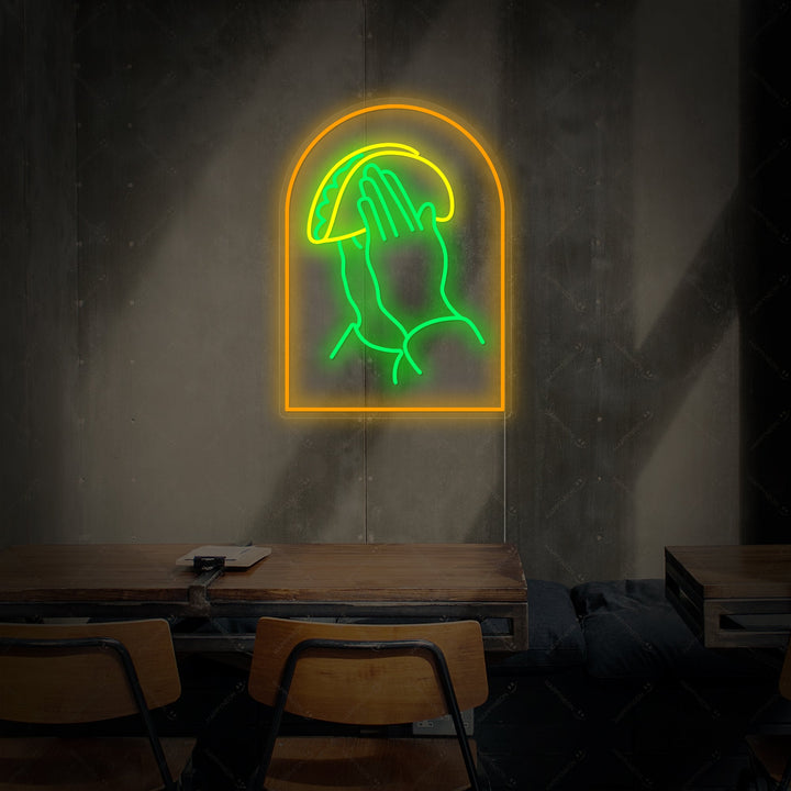 A product shot of the 'Praying Hands With Tacos' neon sign, clearly showing the colorful glowing design against a simple background.