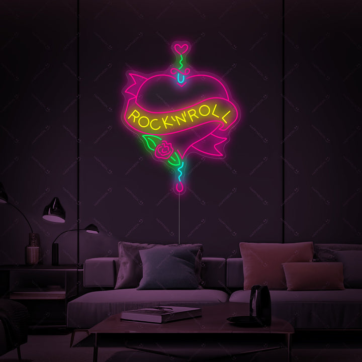 A detailed view of the Rock N Roll neon sign, showing the glowing red and blue tubes against its secure backing. The sign reads 'ROCK N ROLL' in a bold, dynamic font with small lightning bolt details, ready for wall mounting in any music-themed space.
