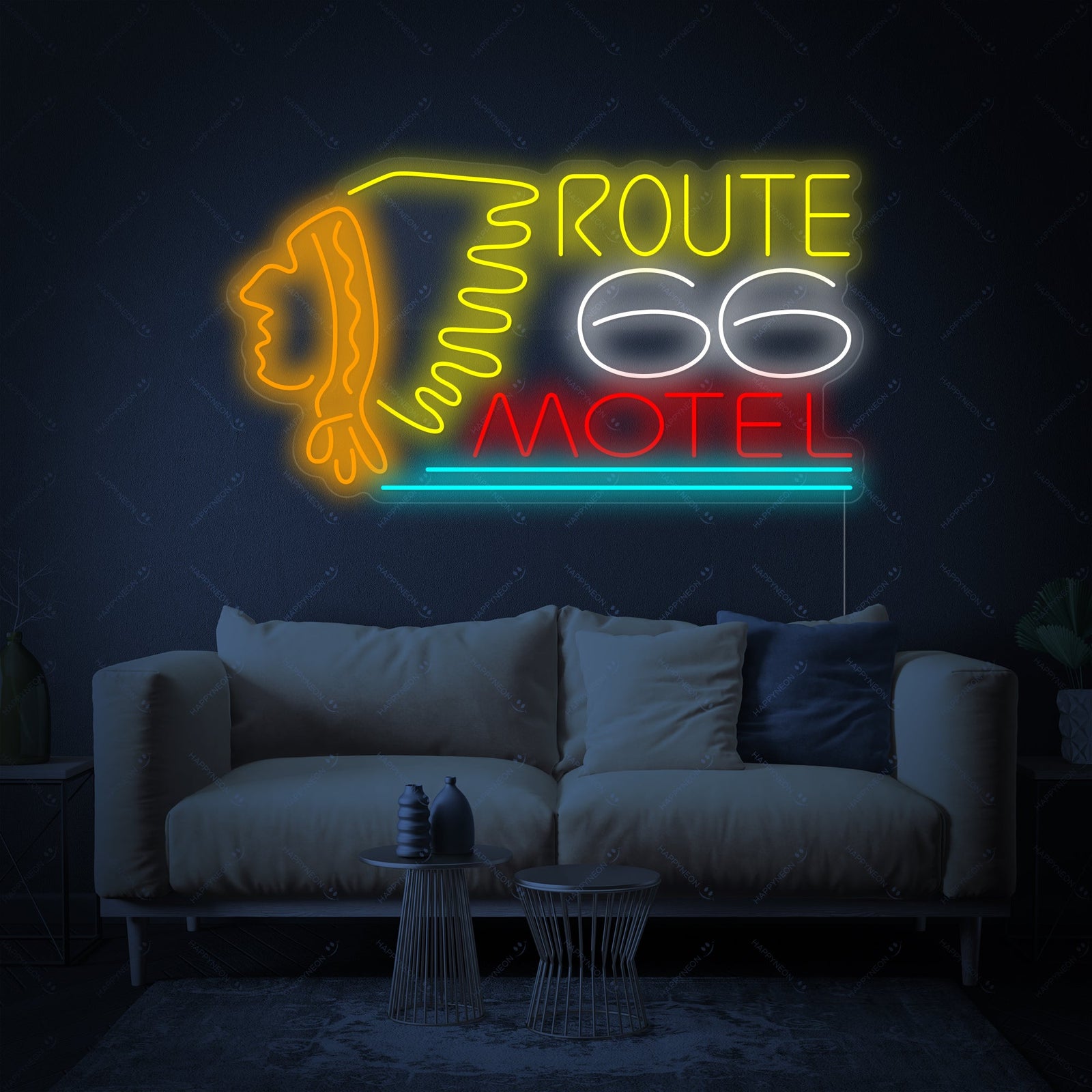 Detail view of the Route 66 Motel neon sign showing the blue and orange tubing illuminated against a dark background.