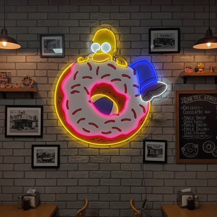 Photograph of the vibrant pink donut neon sign illuminated and mounted above a stylized cafe counter, showing the power cord and installation