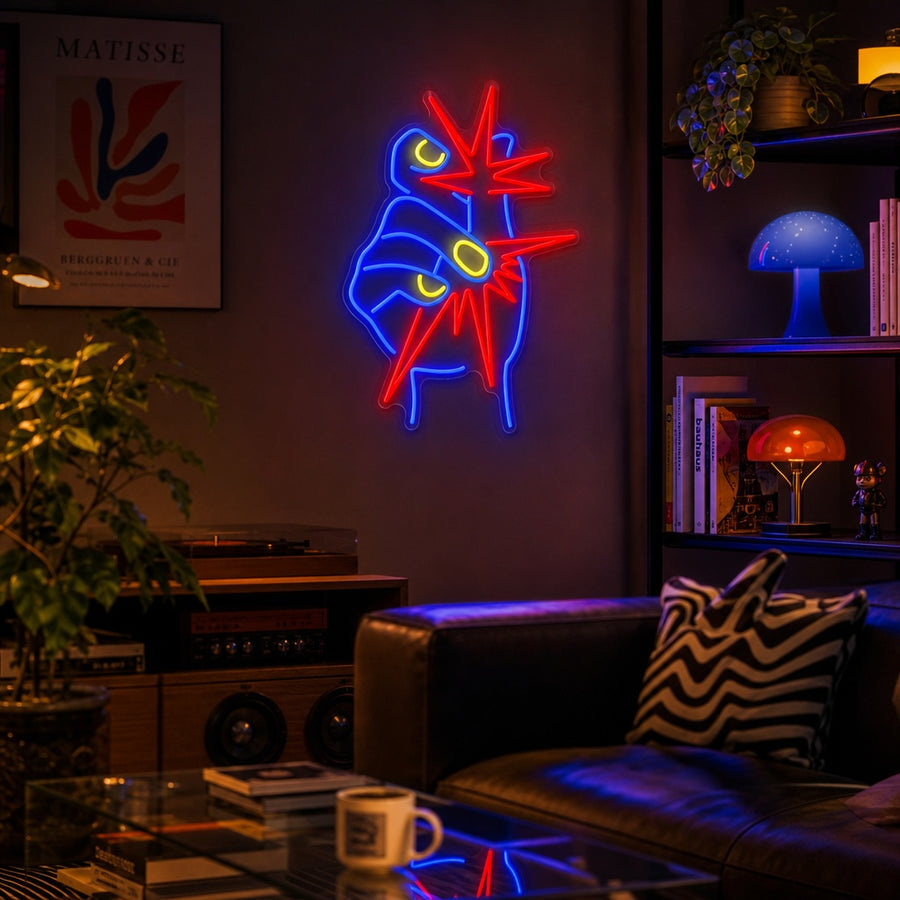 A glowing 'Snap Explosion' graphic neon sign displayed as a piece of vibrant wall decor above a dark blue sofa in a modern living room setting.