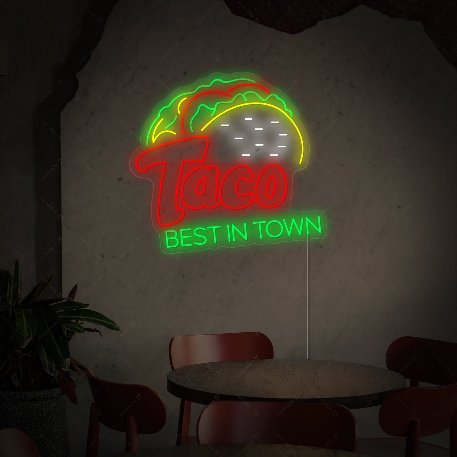 Close-up view of the glowing blue 'Best In Town' text and yellow taco graphic on the 'Taco Best In Town' neon sign.