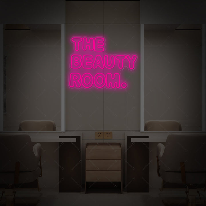 A high-quality neon sign displaying 'The Beauty Room' in elegant script, with visible tube geometry and a physical backing, set against a chic, symmetrical salon background.