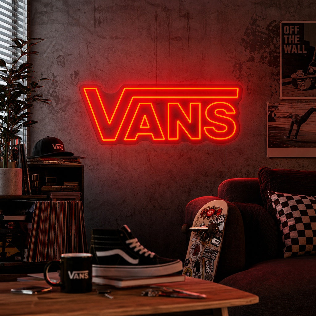 A glowing red Vans neon sign mounted on a dark brick wall in a lifestyle setting.