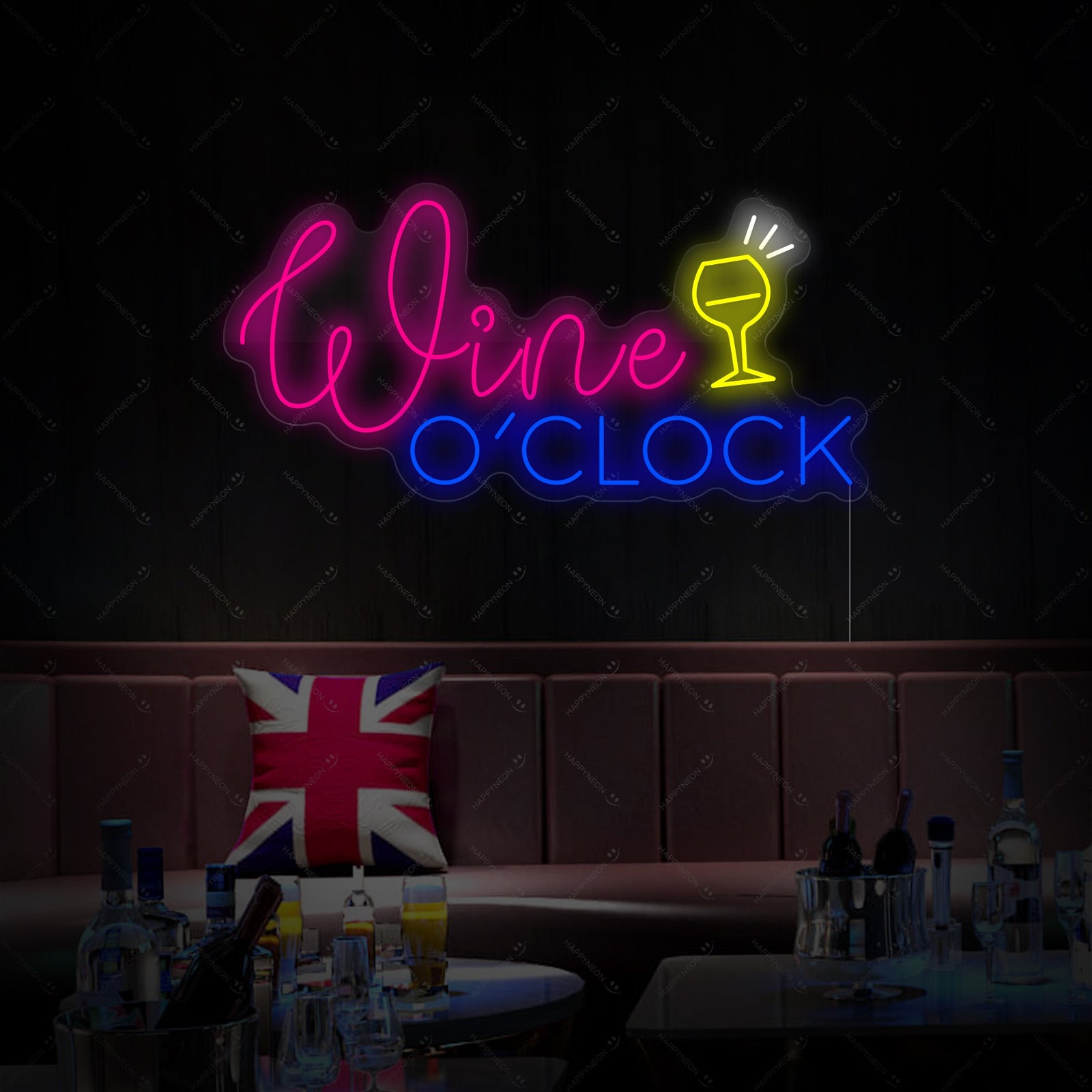 Close-up detail of the illuminated Wine O'clock neon sign with its protective backboard.