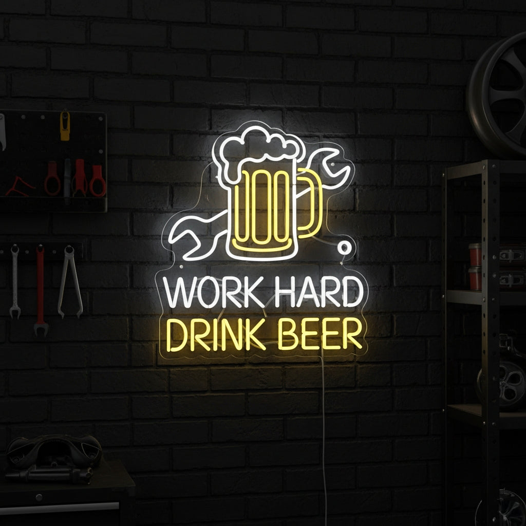 Illuminated Work Hard Drink Beer neon sign on a wood panel wall in a home bar setting, next to beer bottles and decorative plants.