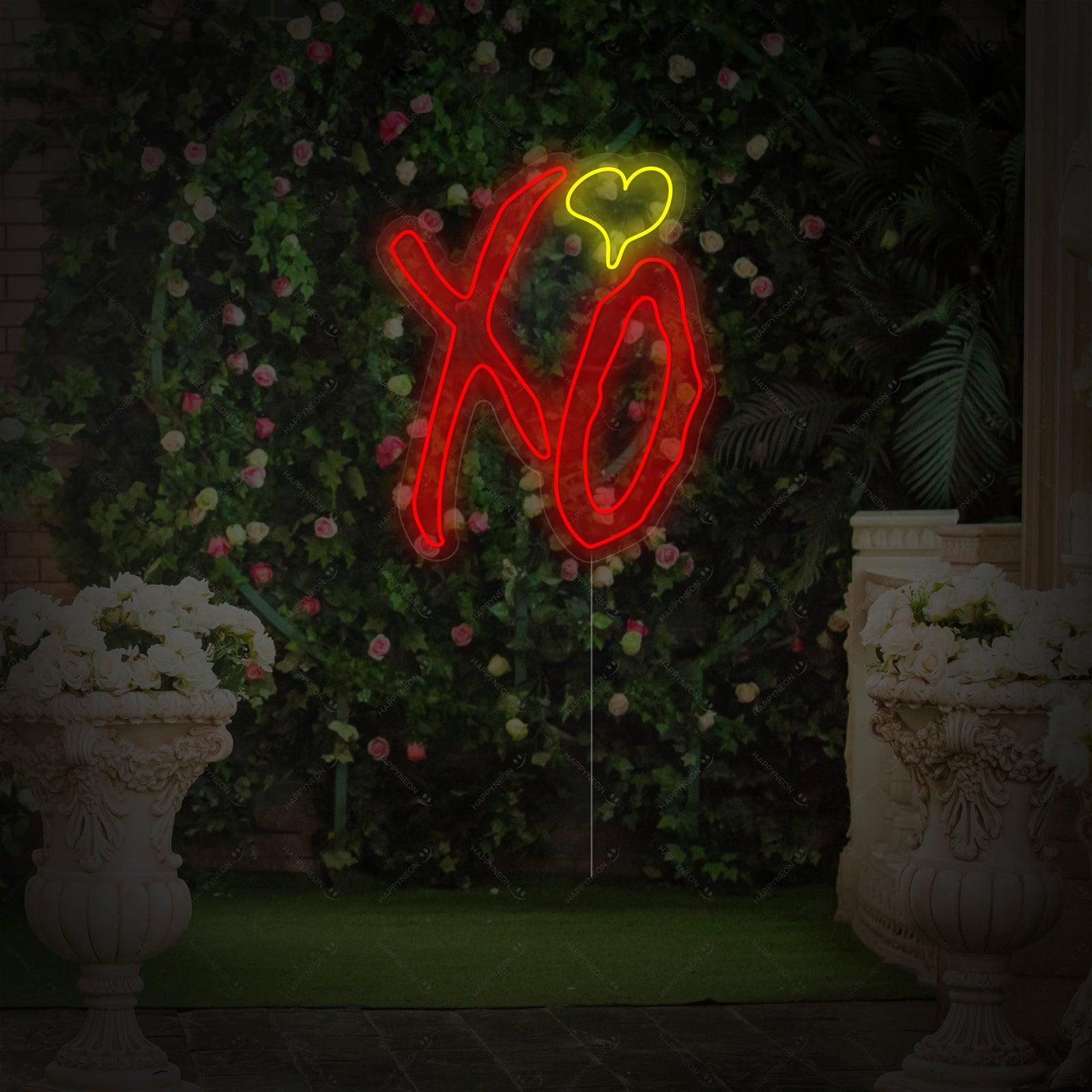 A clean, graphic style product photograph showing the stylized, glowing pink "XO" letters forming the neon sign against a solid dark grey background, illustrating the full sign design and clear acrylic backing.