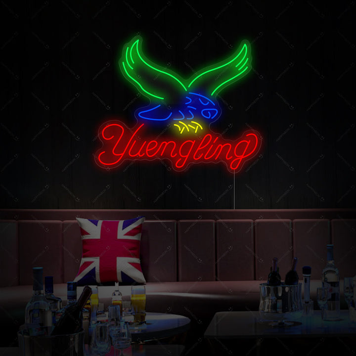 A Yuengling neon sign, featuring the classic script logo and eagle graphic in red and white.