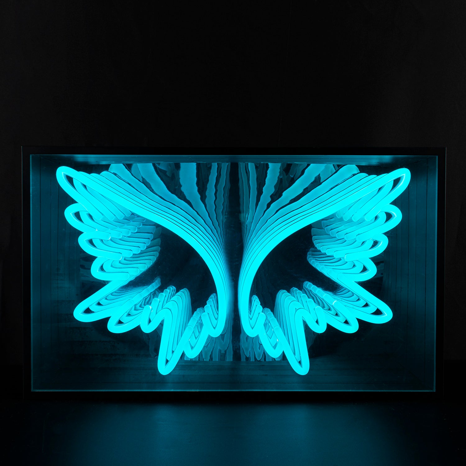 A stunning 'Angel Wings' 3D Infinity Neon Sign glowing brightly on a wall, showcasing the mesmerizing endless reflection effect.