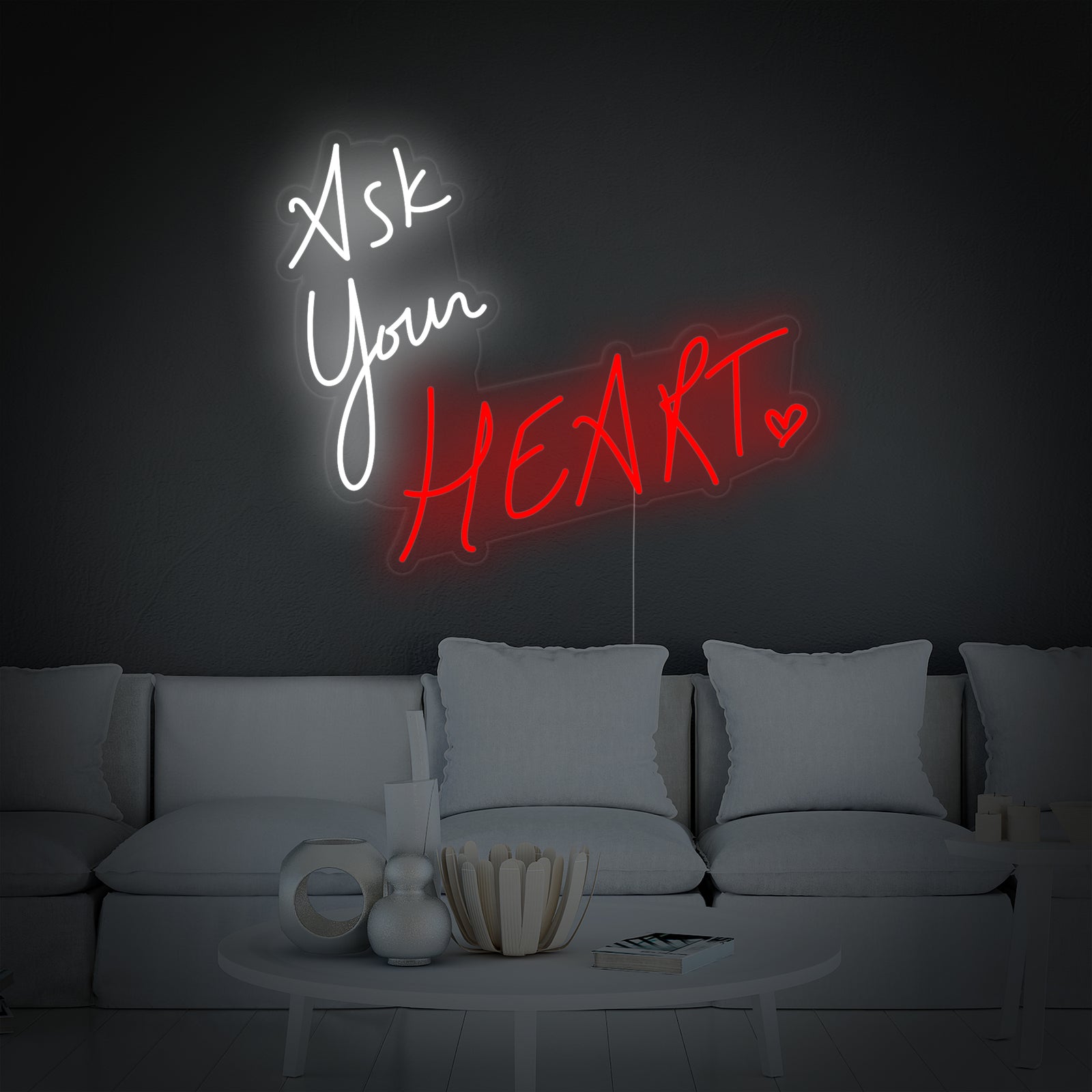 Closeup view of the 'Ask Your Heart' glowing neon sign mounted on a clean white wall, showcasing the pink script font and acrylic backing.