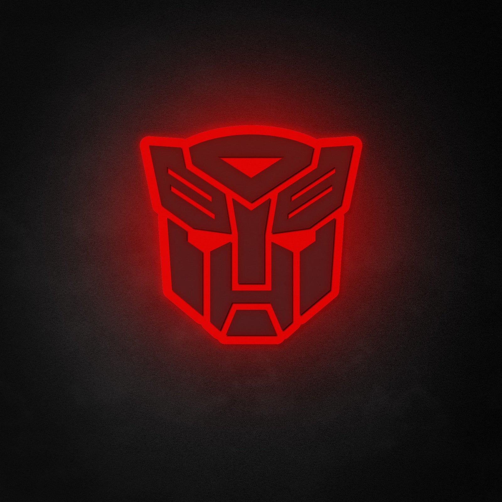 A vibrant red Autobot neon sign glows brightly against a dark, textured wall, showcasing the classic Transformers logo design.