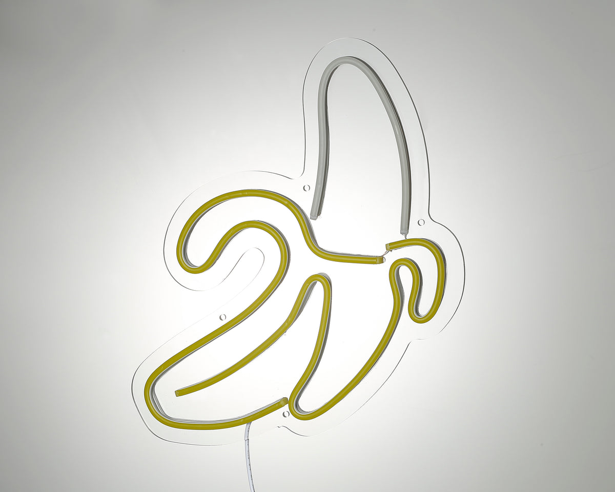 Close up of unlit banana shape neon sign on acrylic backing