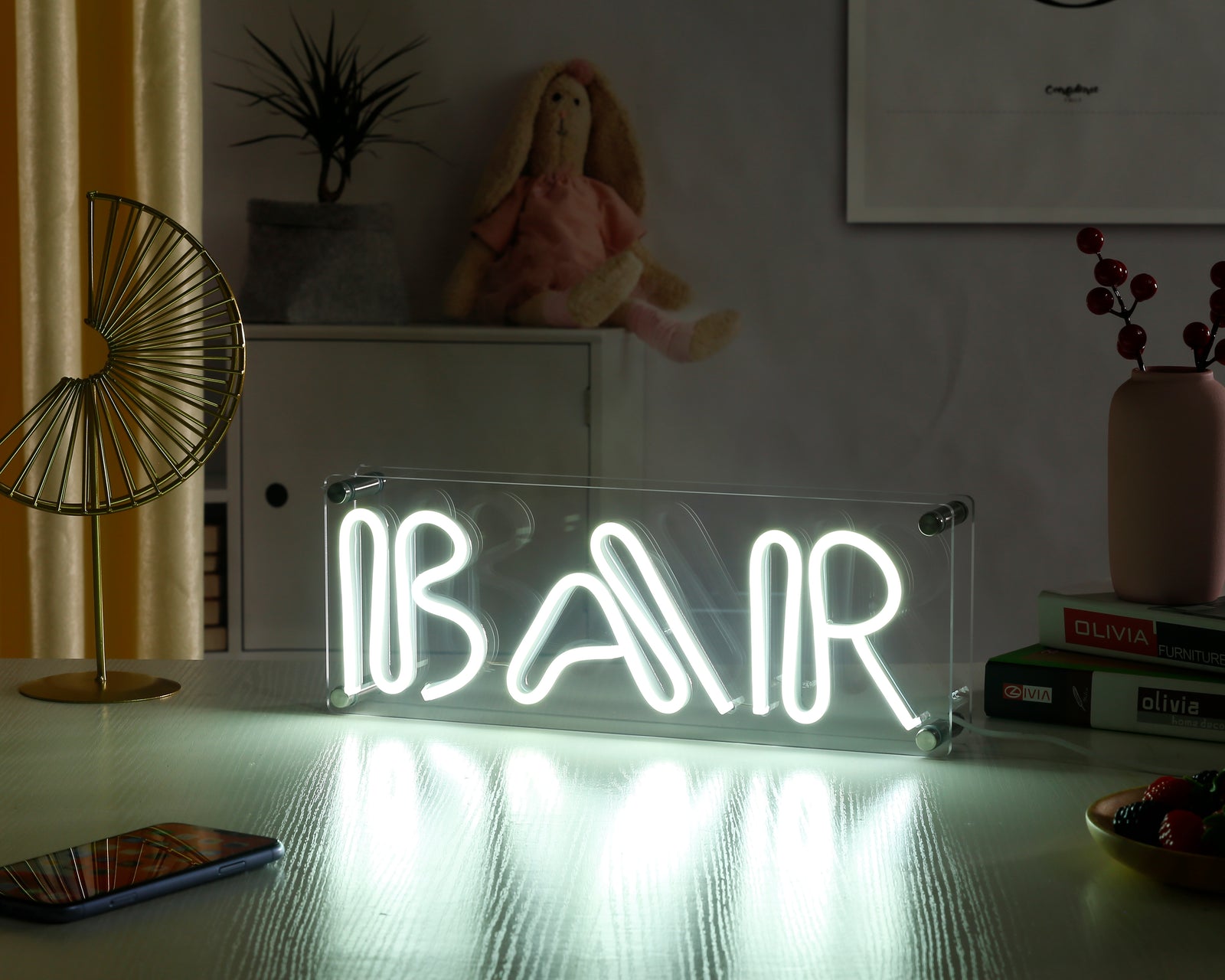 Vibrant "Bar" neon sign glowing green on a modern wooden desk.