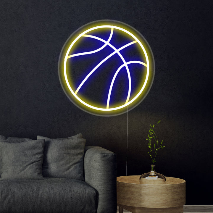 Close-up photograph of a glowing orange 'Basketball' neon sign against a dark textured brick wall.