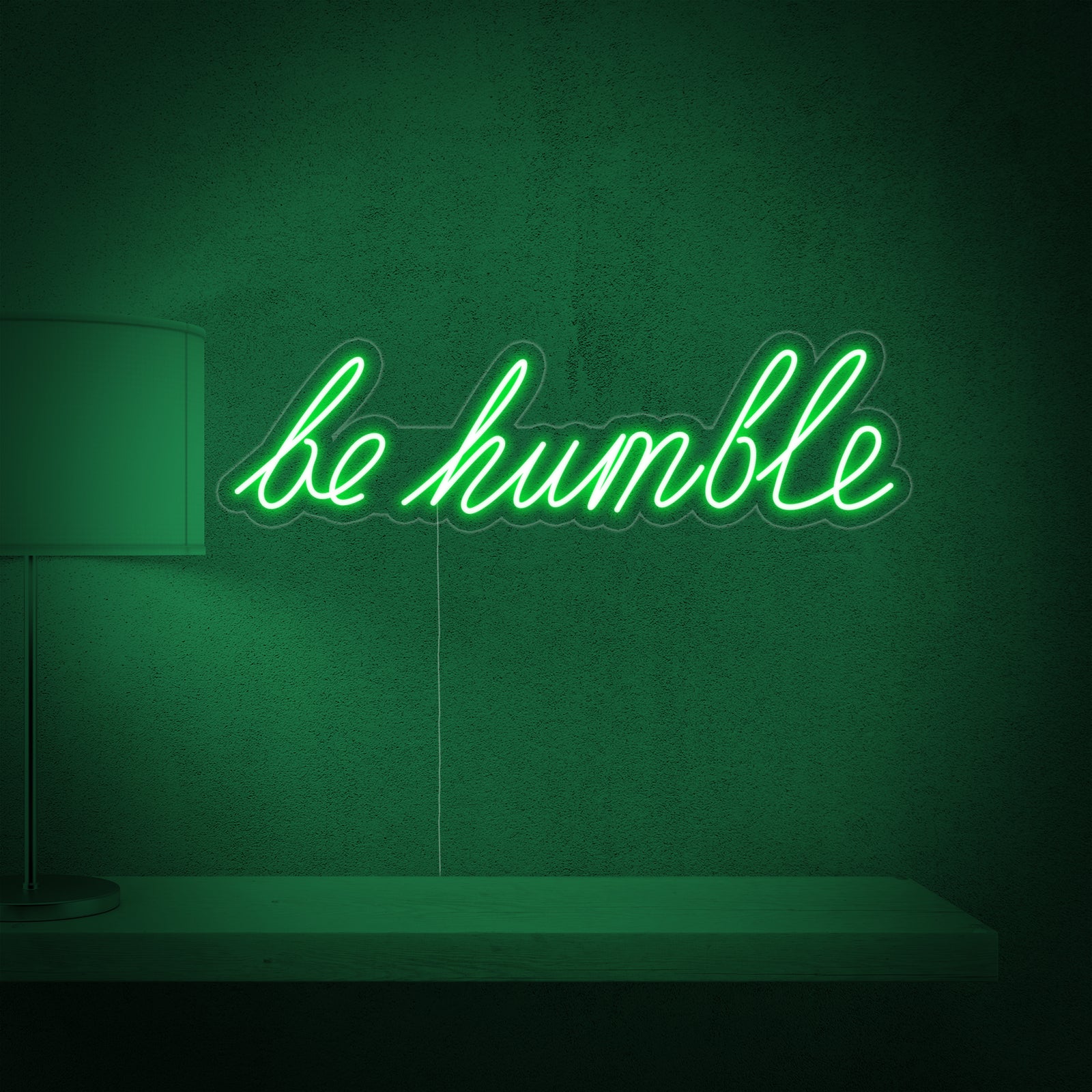 The 'Be Humble' neon sign on a minimalist textured wall.