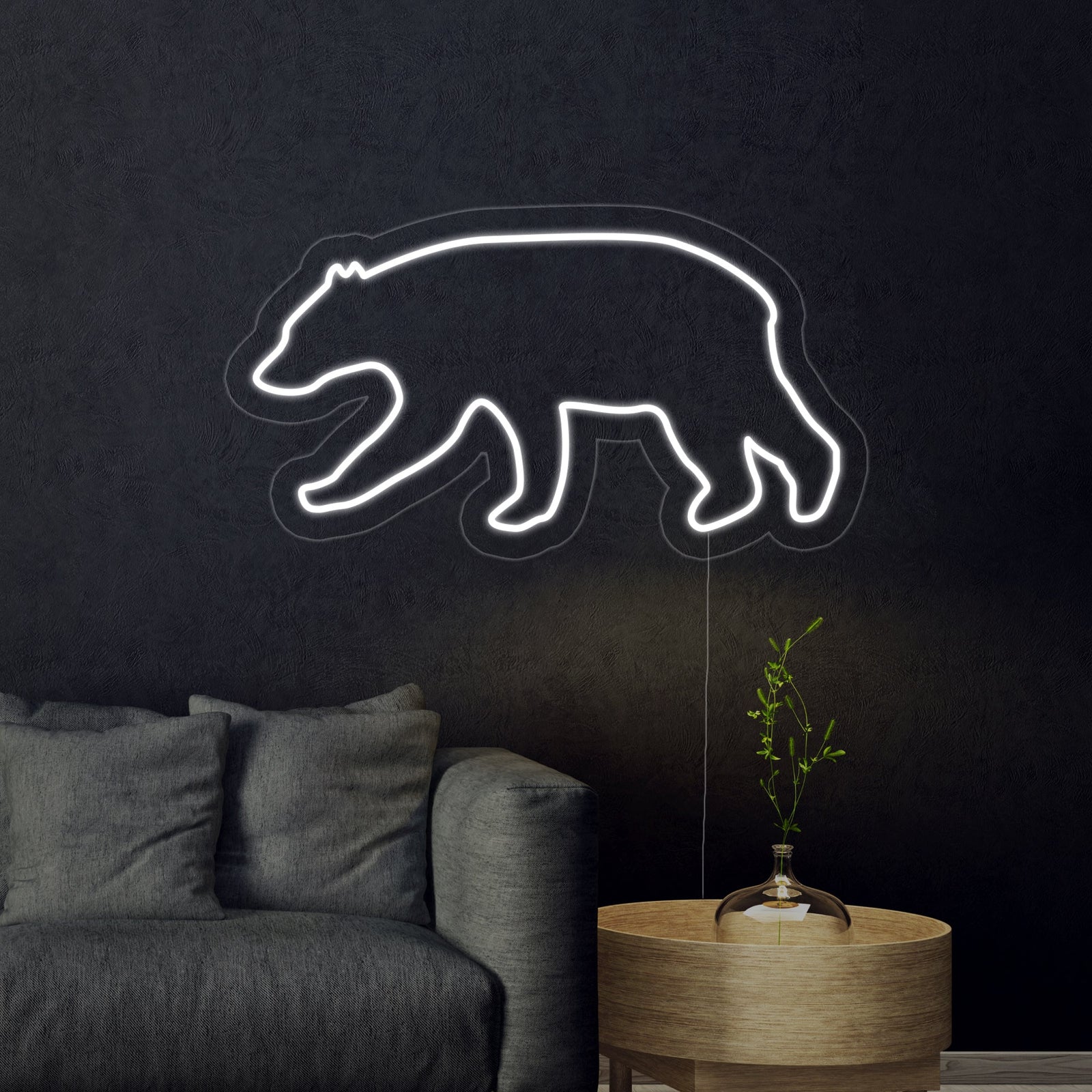 A clean, graphic style mockup of a lit Bear-shaped neon light sign, featuring a friendly design with prominent ears, glowing brightly against a simple dark grey background.