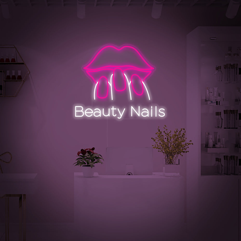 A glowing "Beauty Nails" neon sign in pink and white fonts, mounted on a dark background showing physical tube details and a clear backing.