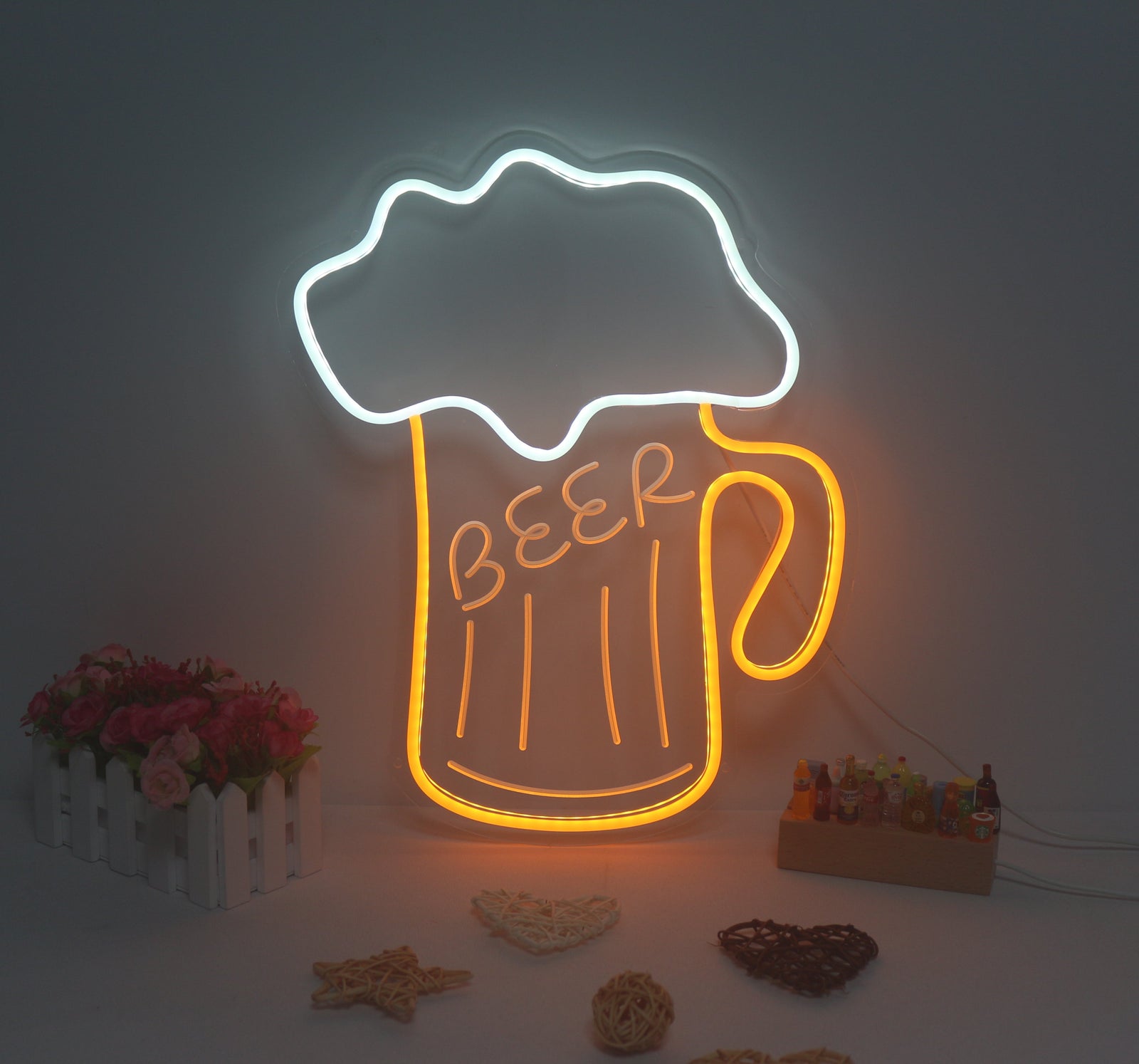 The Beer Drinking Mini Neon Sign, unlit, clearly showing the silicone LED tubing, the transparent acrylic backing, and the power cord.