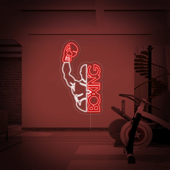 Close-up of a Boxing Man neon sign with glowing outlines mounted on a clear backer against a gym setting.