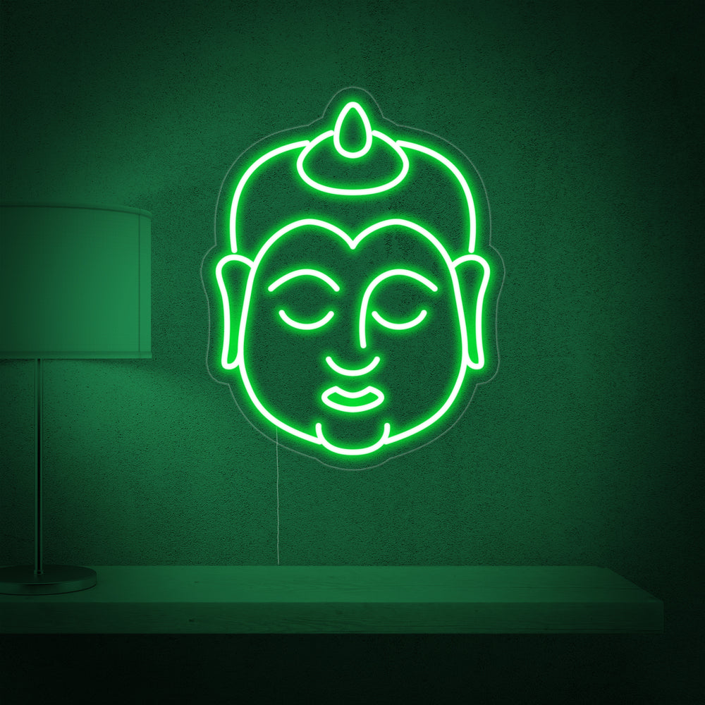 The glowing Buddha neon sign illuminated against a wall, showing the hanging wire and electrical connection.