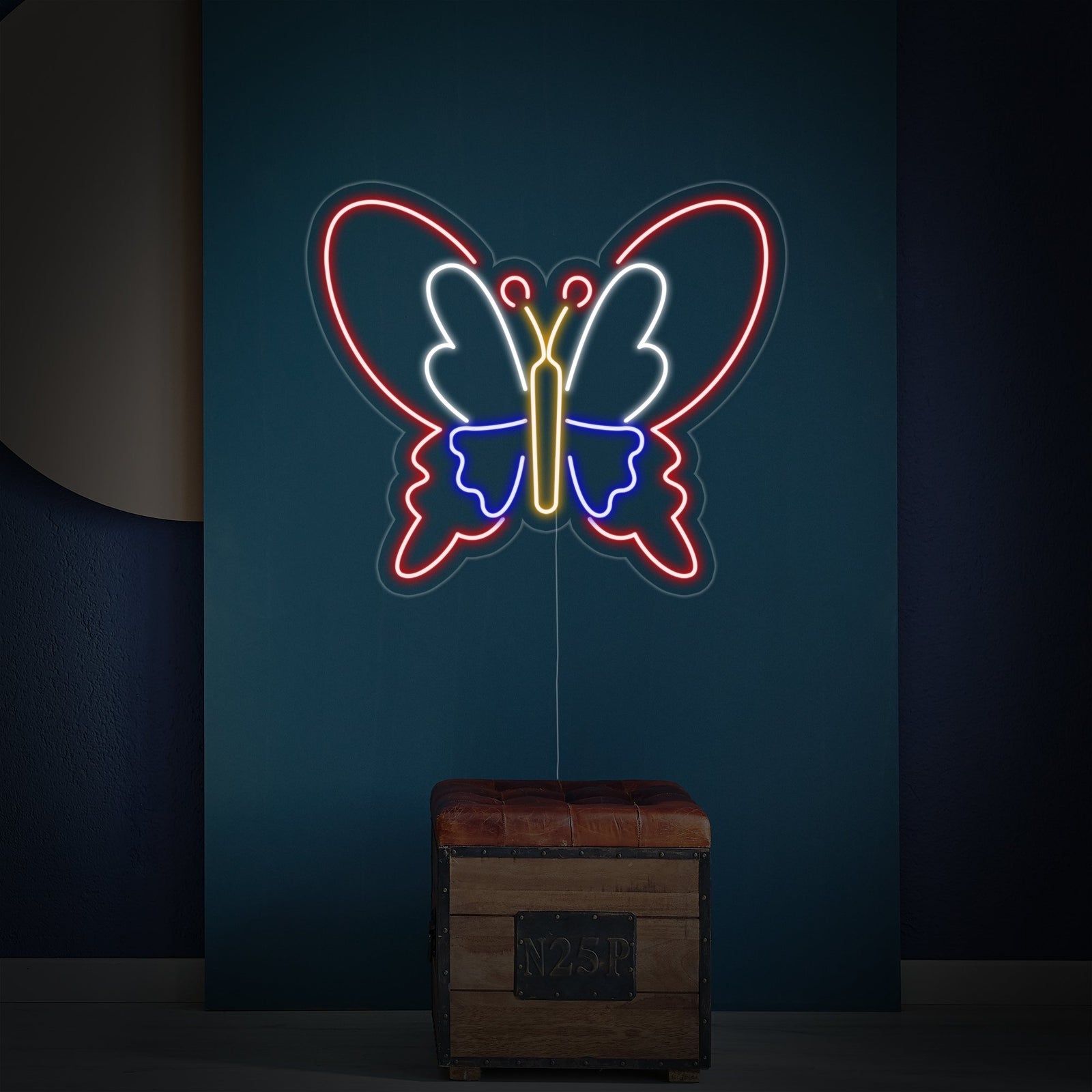 Close-up of a butterfly-shaped neon sign against an exposed brick background.