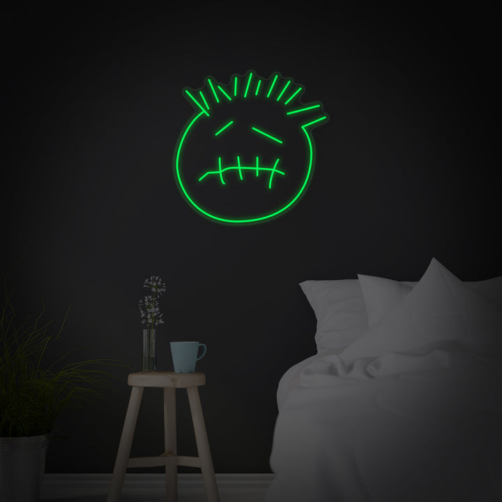 A graphic representation of the 'Cactus Jack Face' neon sign, featuring a frowning face with X's for eyes and messy hair.