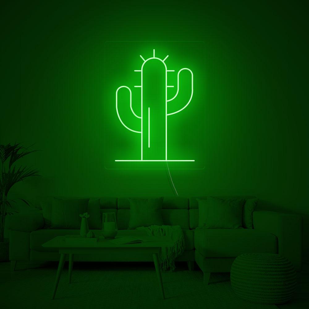 A close-up shot of the green cactus neon sign showing the light tubing detail and glowing effect against a plain background.