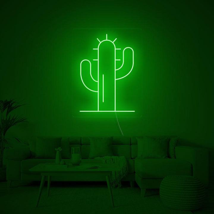 A close-up shot of the green cactus neon sign showing the light tubing detail and glowing effect against a plain background.