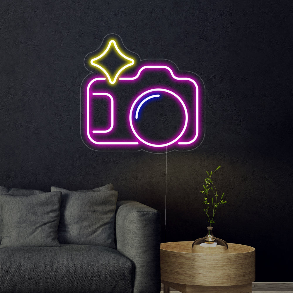 Detailed shot of the 'Camera' neon sign showing the distinct glowing outlines of a classic photographic camera.