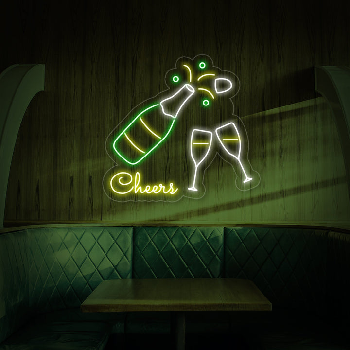 Studio product shot of the 'Champagne Bottle Glasses Cheers' neon sign displaying the details of the neon tubes and clear acrylic backing, set against a blurred background.