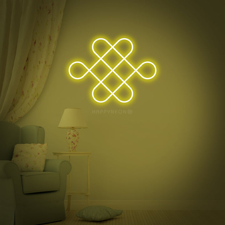 A glowing red and gold Chinese traditional character emblem neon wall sign, mounted above a velvet armchair, casting reflections on the textured wall.