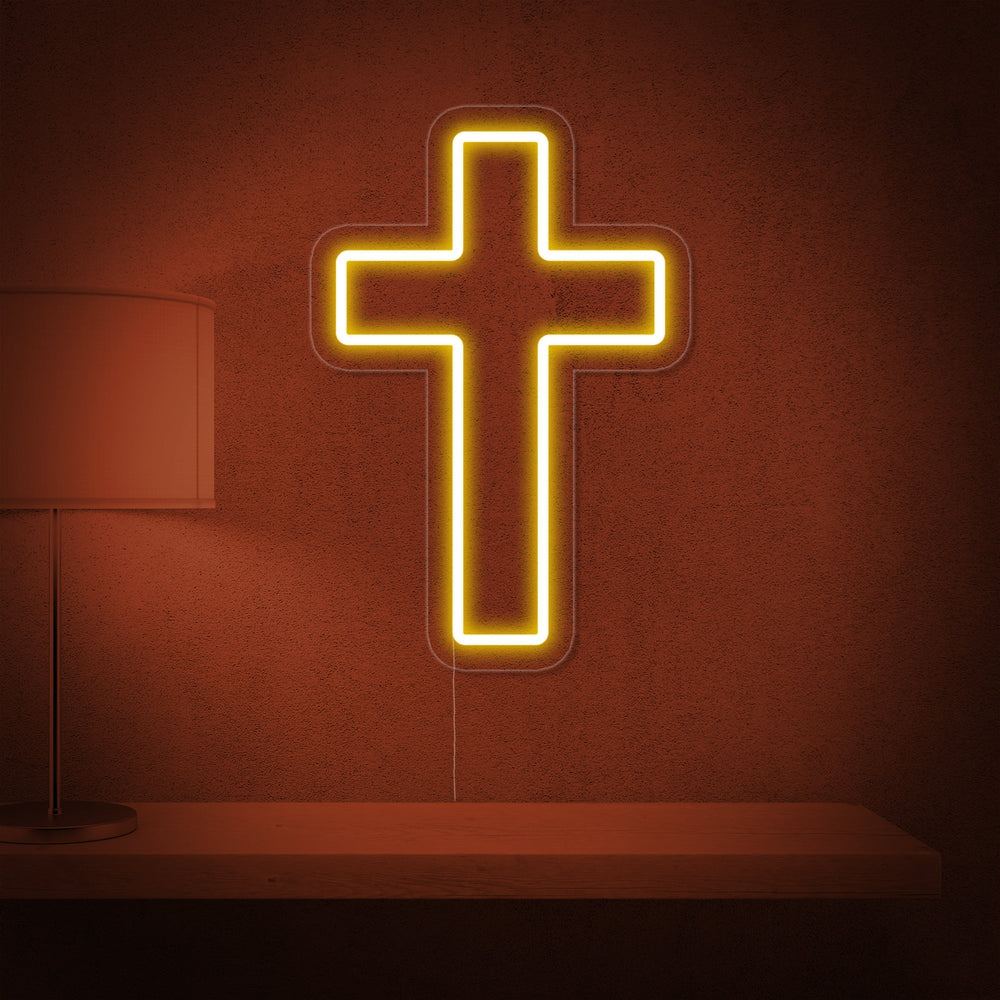 Close-up photograph of a brightly lit Christian Cross Neon Sign featuring white neon tubing on a clear acrylic background.