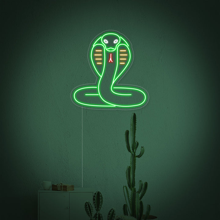 The glowing red neon outline of a coiled cobra snake with its hood flared, mounted on a transparent acrylic backing plate.