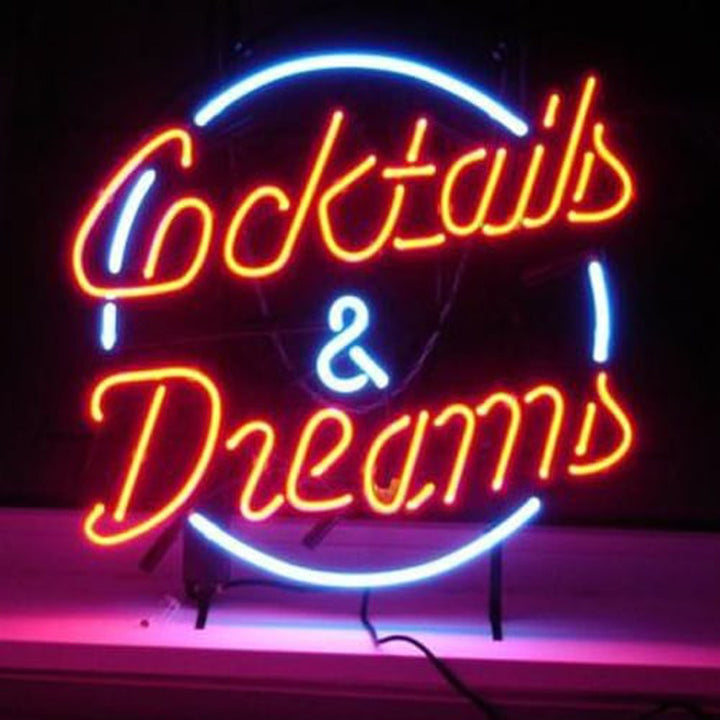 A real photograph of a completed Cocktails and Dreams neon sign glowing on a simple surface, showing the craftsmanship.