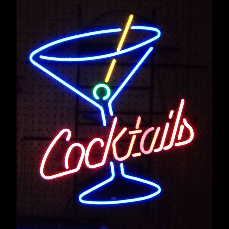 A Cocktails neon sign displaying a glowing cocktail glass and 'Cocktails' text, hanging against a dark pegboard wall.