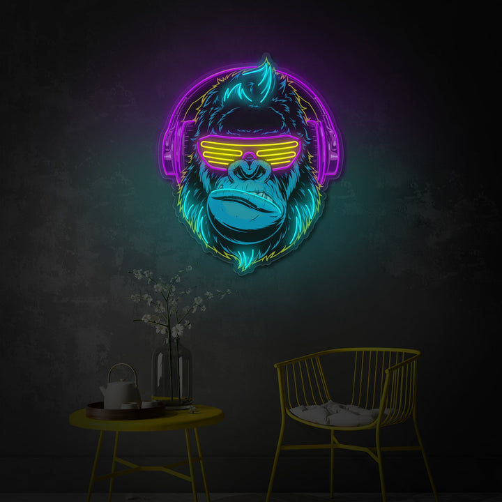 A close-up view of the Cyberpunk Monkey neon wall decor, showing the detailed UV printed ape graphic and the vibrant glow of the surrounding neon tubing, mounted on a dark textured wall next to a modern gaming desk.