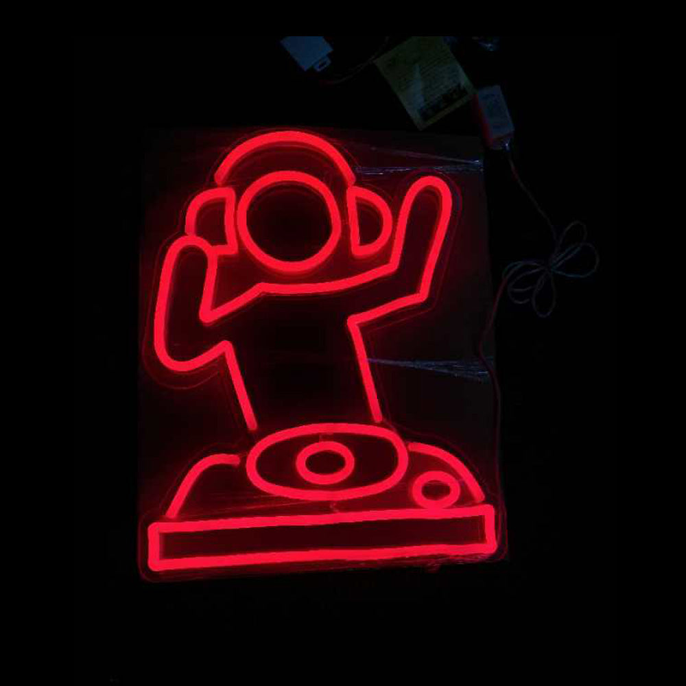 A vibrant neon wall sign depicting stylized headphones, two stars, and the text 'DJ MODEL' in blue and yellow glowing light, mounted on a wall.