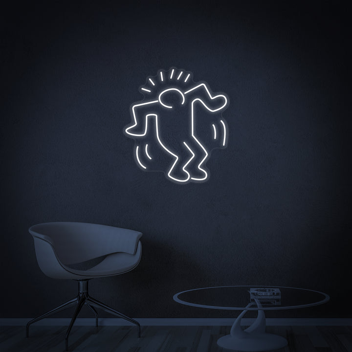 A wider shot showing the 'Dancing Man' neon sign illuminated, adding a cool white glow to a modern interior space with plants.