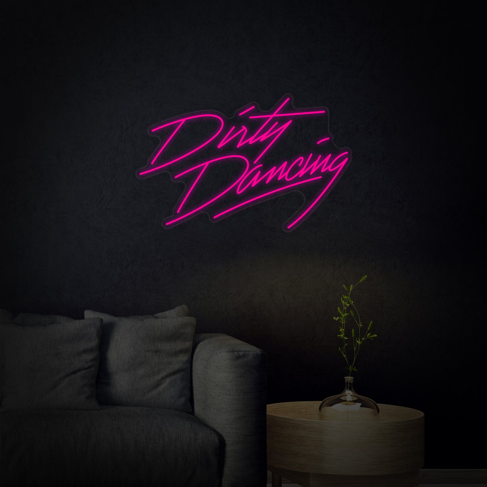 A glowing orange and pink Dirty Dancing neon sign, made from flexible tubes, with a clear acrylic backboard and visible power cable against a plain wall. Direct, high-quality design source shot.
