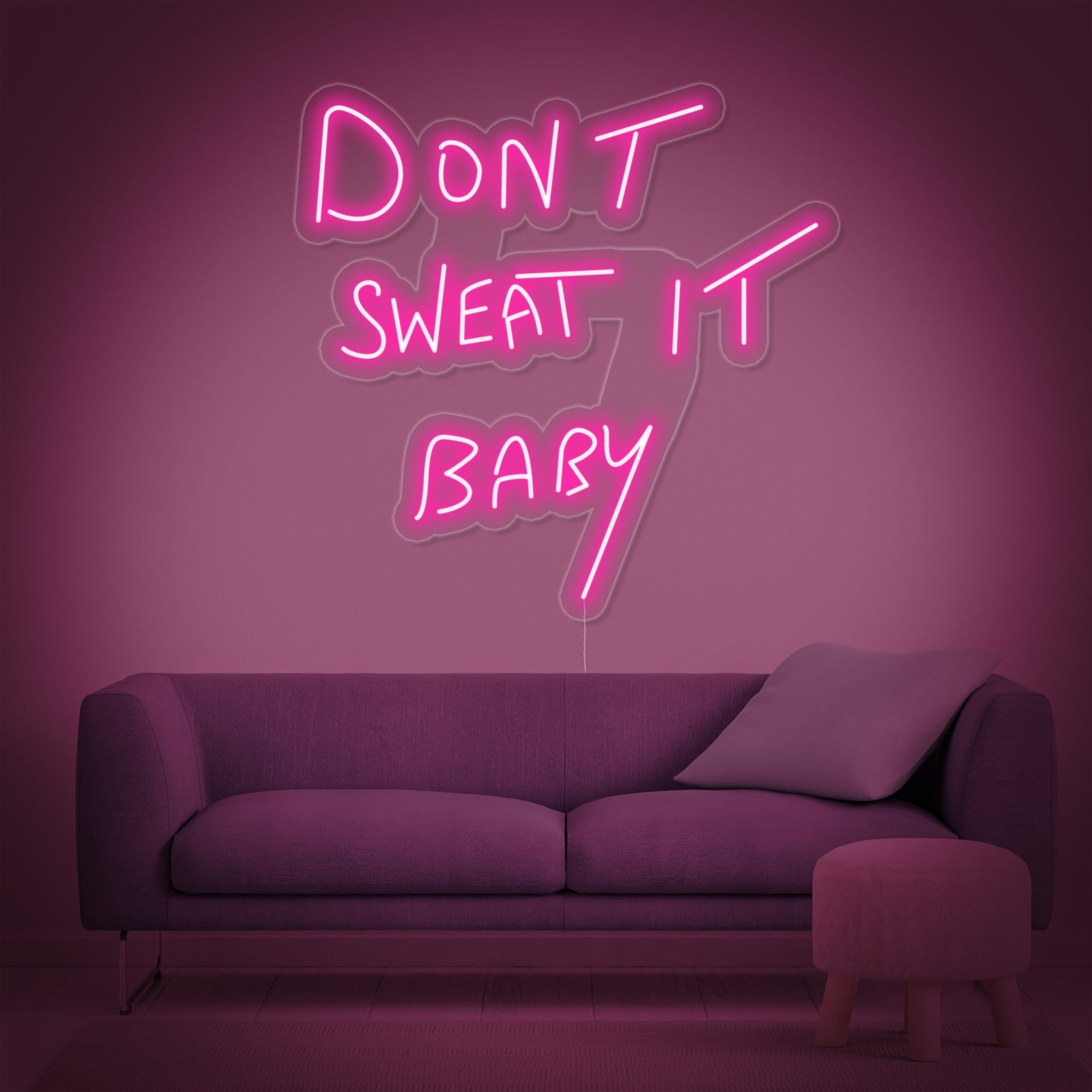 Stylized product view of the 'Dont Sweat it Baby' neon sign against a neutral wall.