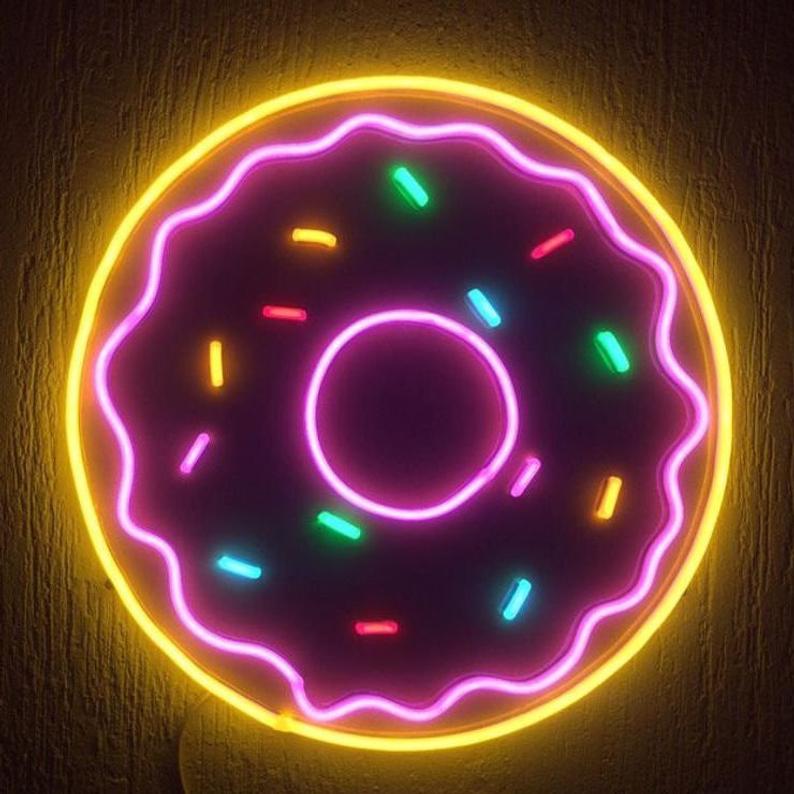 A graphic design mockup of a donut neon sign displayed on a white textured wall.