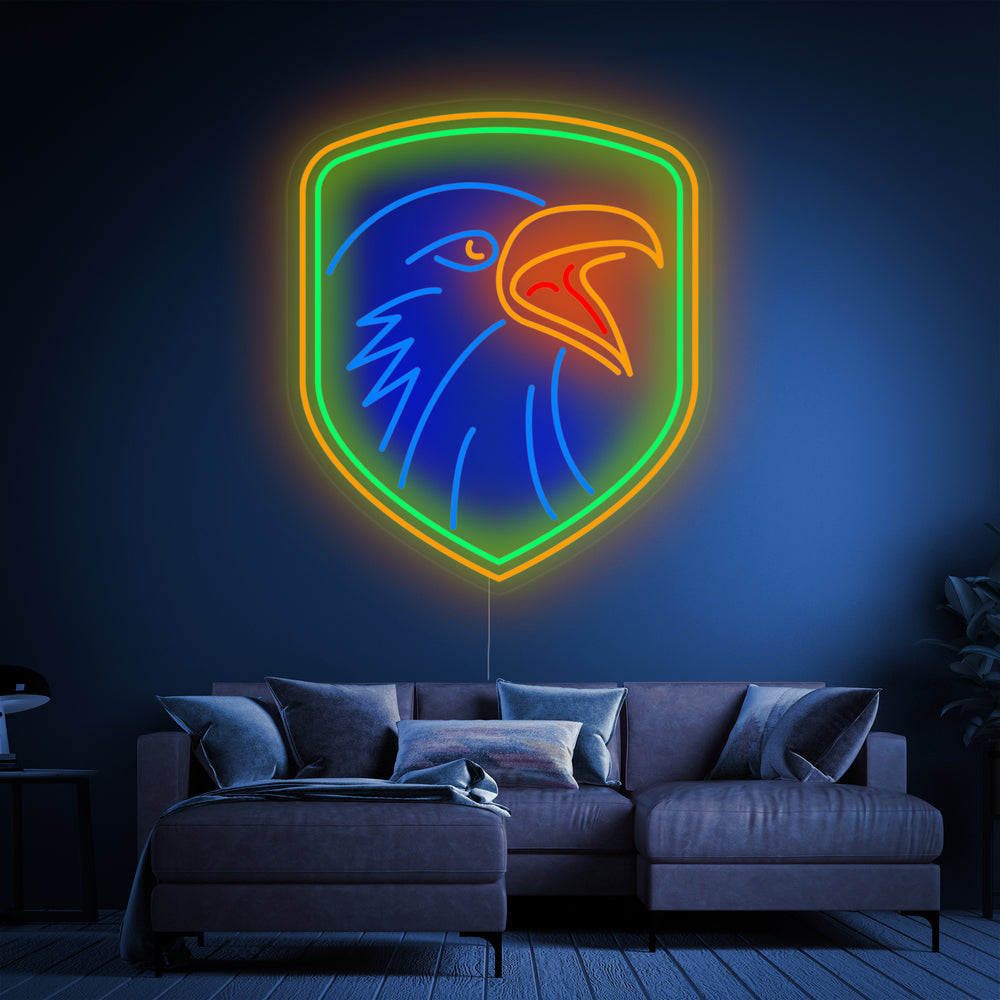 A clean graphic illustration of an eagle with a shield in blue and yellow neon outline on a dark brick background.