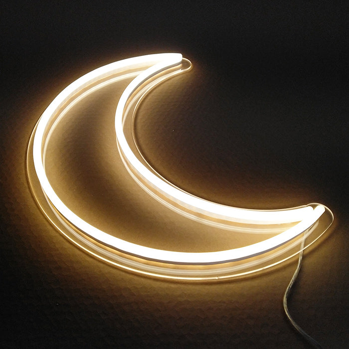 "Element Symbol Moon" neon sign glowing brightly on a dark wall.