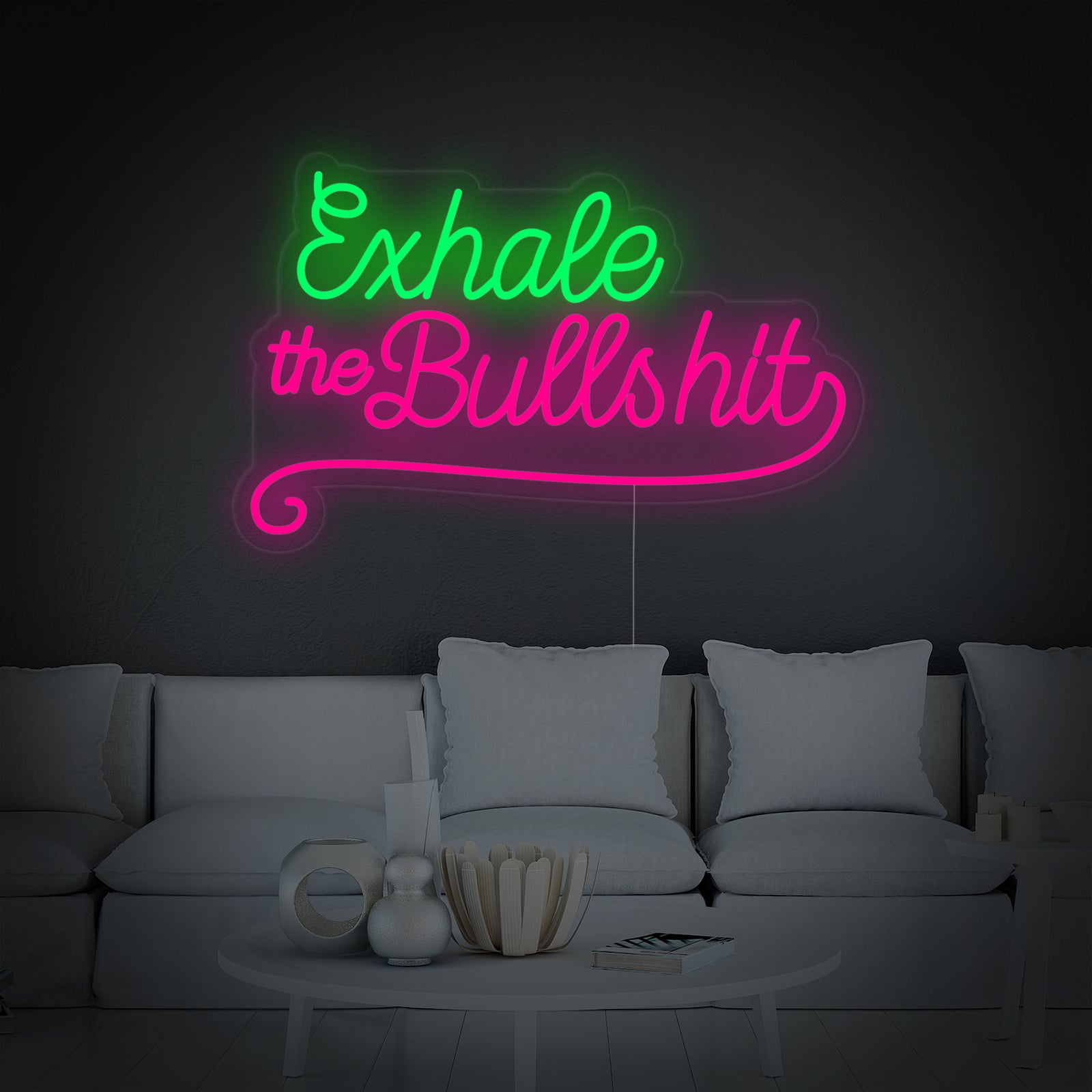 A clean, direct image of the 'Exhale The Bullshit' neon sign glowing brightly with white neon tubing against a natural-colored concrete wall.
