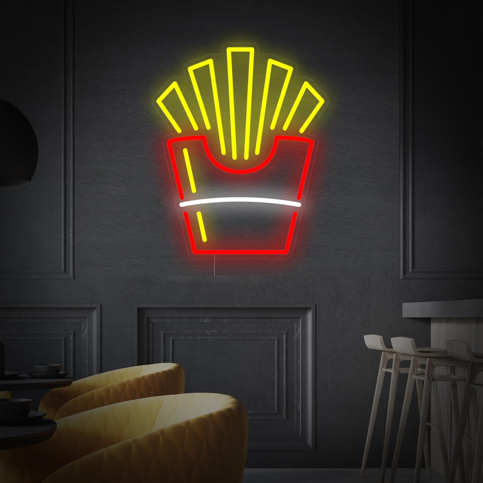 A graphic design mockup showing a glowing French Fried Potatoes neon sign, featuring yellow fries in a paper cup with a red heart, mounted on an acrylic backing against an blurred indoor background.