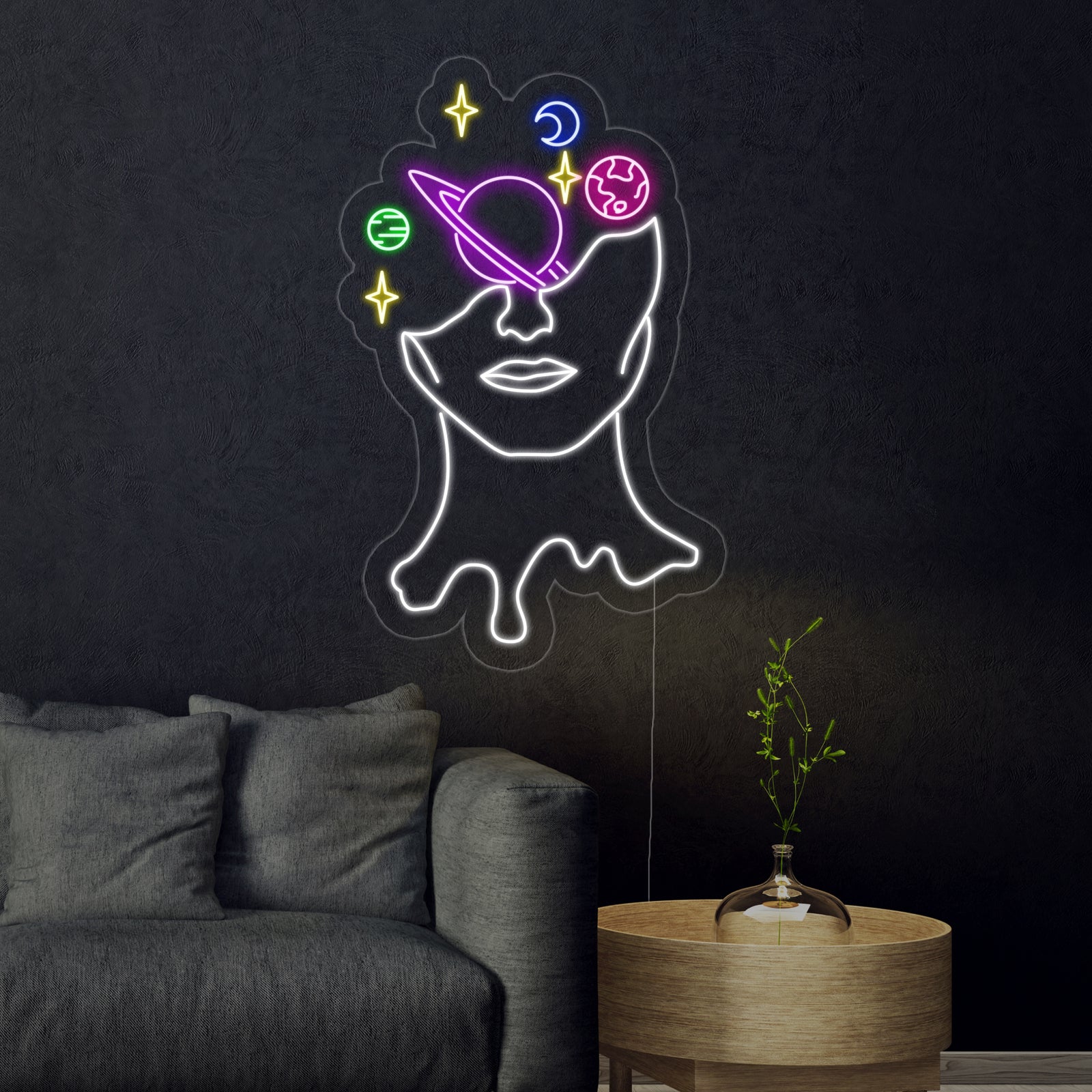 The glowing 'Galaxy Brain' neon sign mounted on a living room wall above a sofa, illuminating the space with its cosmic design.